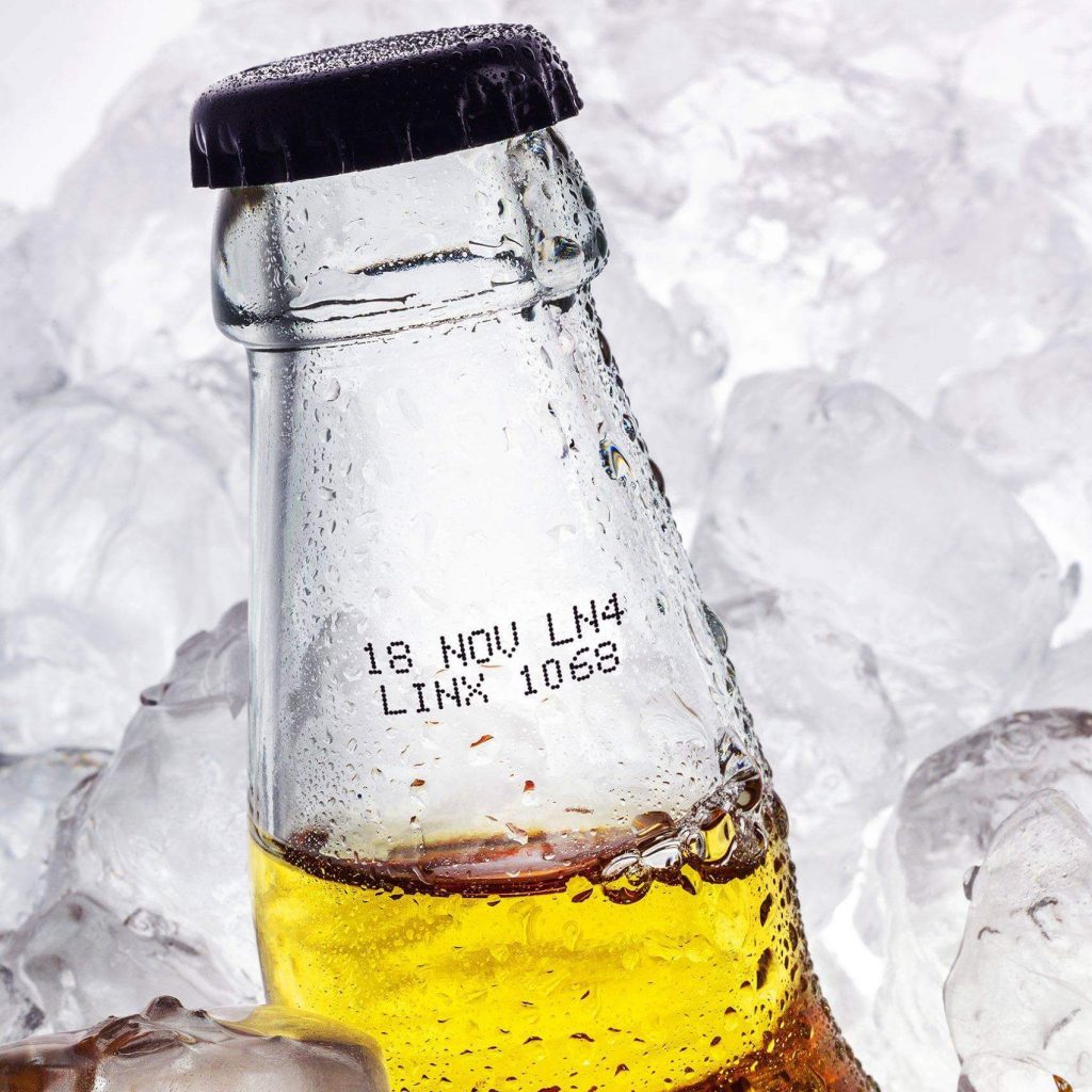 date and batch code marking on glass bottle surrounding with ices